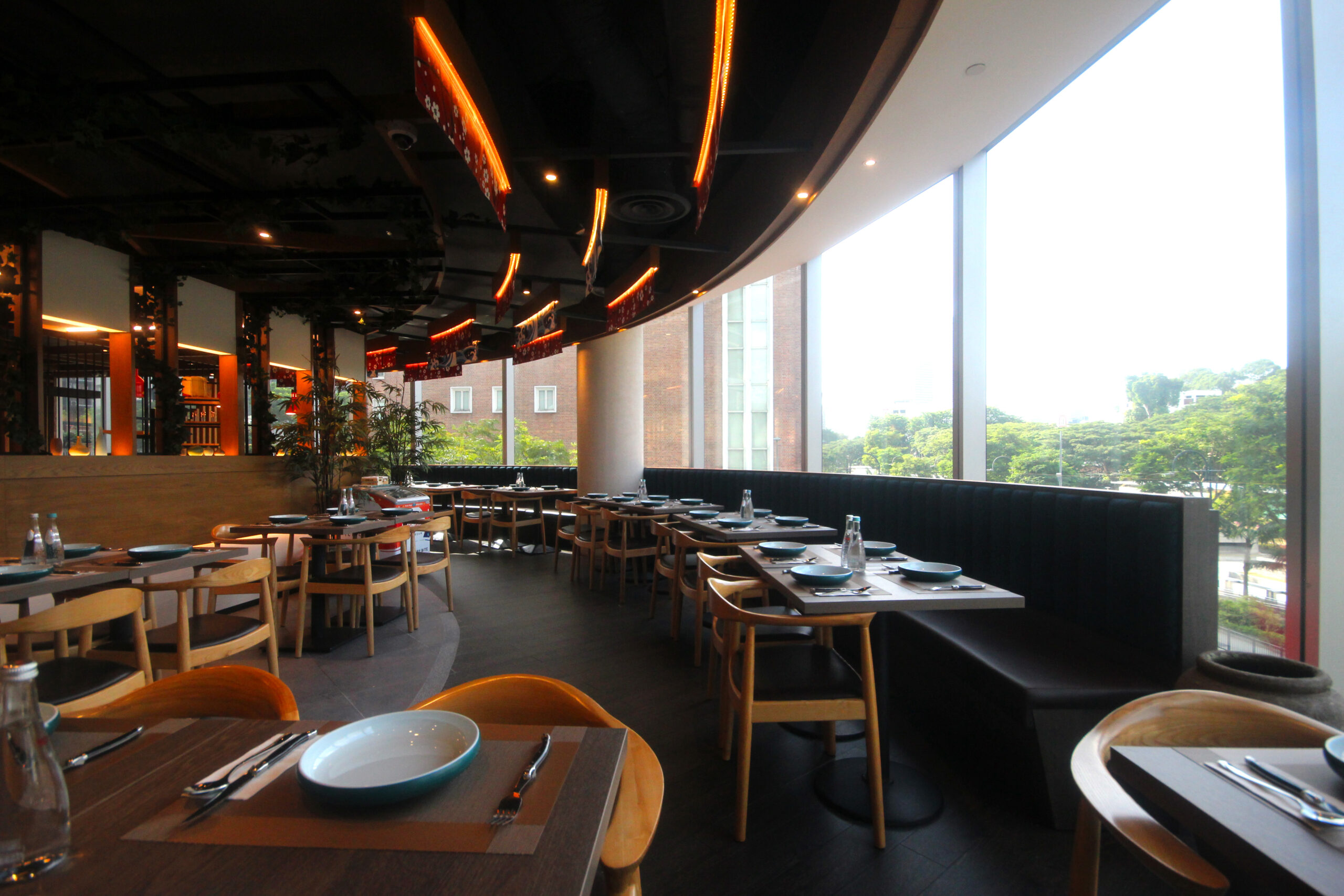 Dining space with extensive window panel showing Singapore's City view at BIZEN located in Plaza Singapura. Perfect for romantic date nights.
