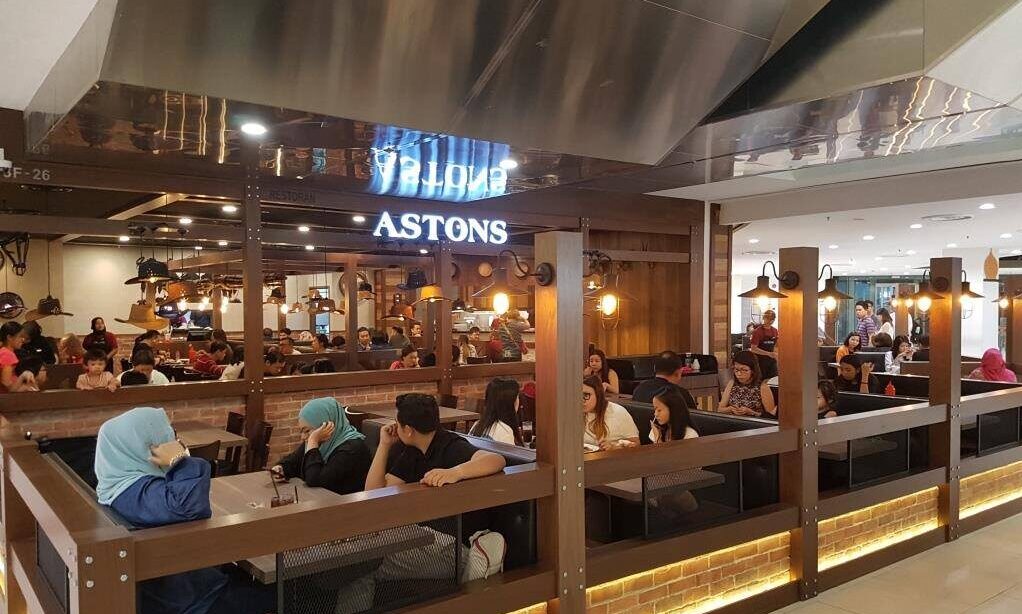 Photo of ASTONS franchise restaurant in Johor Bahru, Malaysia, packed with customers.